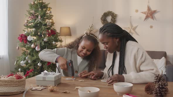 Woman and Girl Making Christmas Decorations