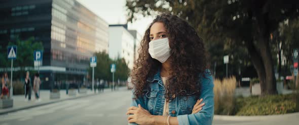 Video of woman in protective mask waiting for a taxi. Shot with RED helium camera in 8K.