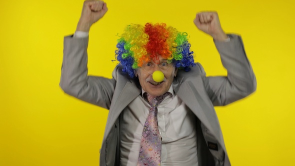 Elderly Old Clown Businessman Freelancer Dancing, Celebrate Victory, Entertains