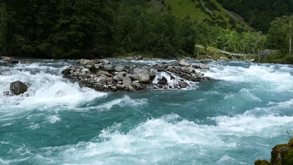 Wild clear blue stream in Morkidsdalen park Skjolden 