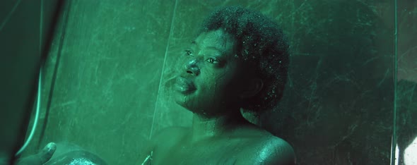 Thoughtful African American Woman Standing in Shower