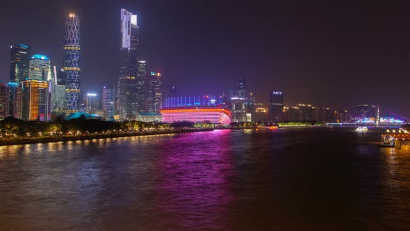 Guangzhou Night Business City Cityscape China Pearl River with Boats Traffic Timelapse Pan Up