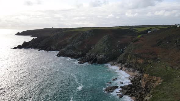 Aerial forward along rocky coast of Minack in Cornwall, England