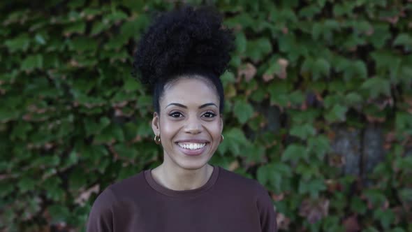 Happy African American Young Adult Woman Smiling Confident at Camera Outdoors
