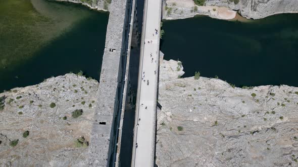 Top-down aerial view of The Pont du Gard, an ancient Roman aqueduct in France