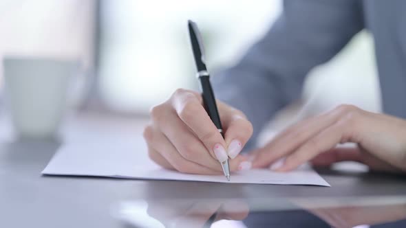 Close Up of Hands of Female Writing on Paper