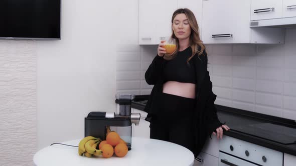 Woman Expecting a Baby Enjoying Orange Vitamin Juice