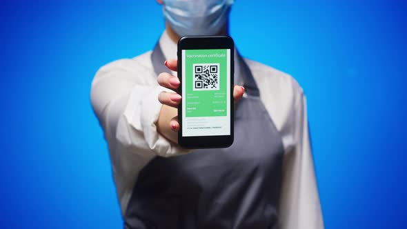 Woman Worker Showing on Phone Vaccination Passport with Qr Code on Blue Background International