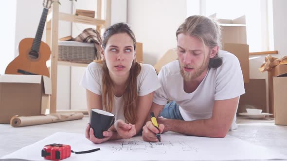 Caucasian Pair Arguing with Each Other About Furnishings of Their New Flat in Slowmotion