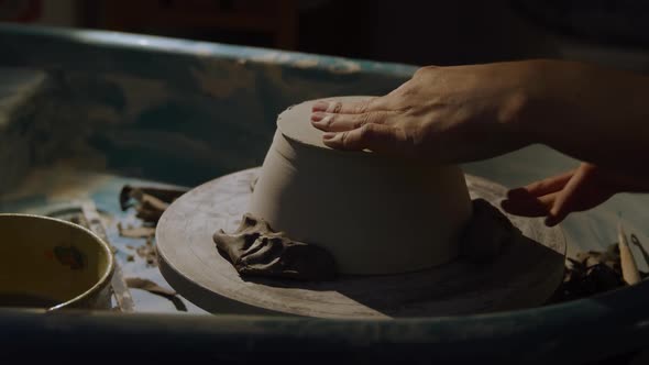 Young female potter working in her studio