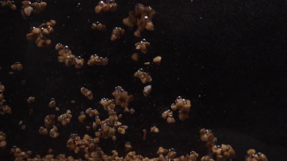 Buckwheat Falls Into Water. Underwater Shooting of Buckwheat. Slow Motion. Food Video