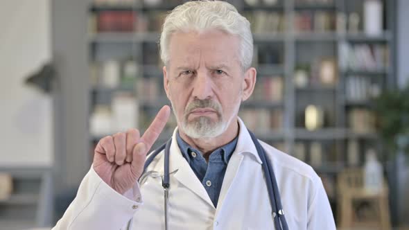 Senior Old Doctor Saying No with Finger Sign