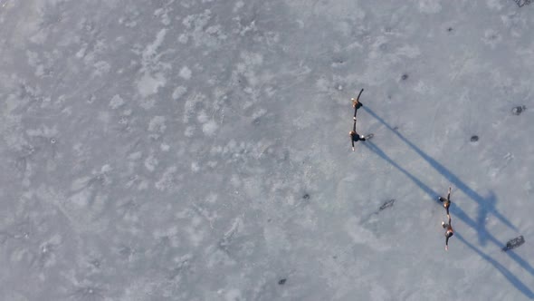 Four young women figure skating on frozen