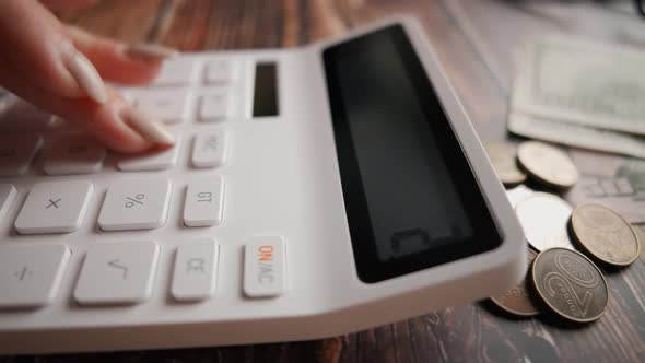 A Woman is Calculating Her Expenses for a Month