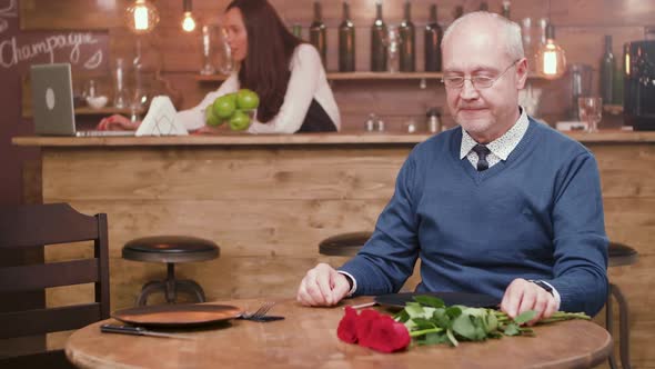 Handsome Senior Man Is Concerned Because His Partner Is Late for the Date