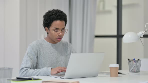 Successful Young African Woman Celebrating on Laptop 