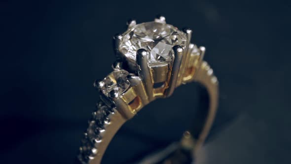 Extreme detailed of diamond ring close up shot while rotating on dark background