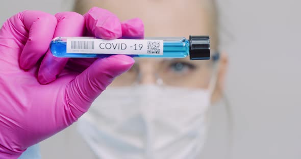 Researcher Holding Covid-19 Sample Tube in Hand
