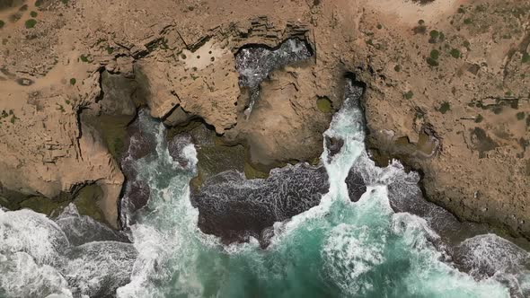 Ocean waves breaking on a rocky shore, Aerial view.