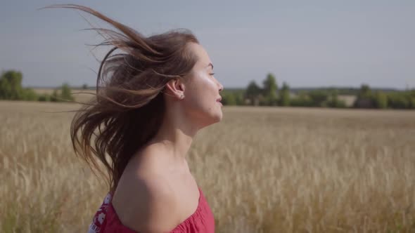 Side View of Beautiful Carefree Woman with Long Hair Running Through the Wheat Field, Hair