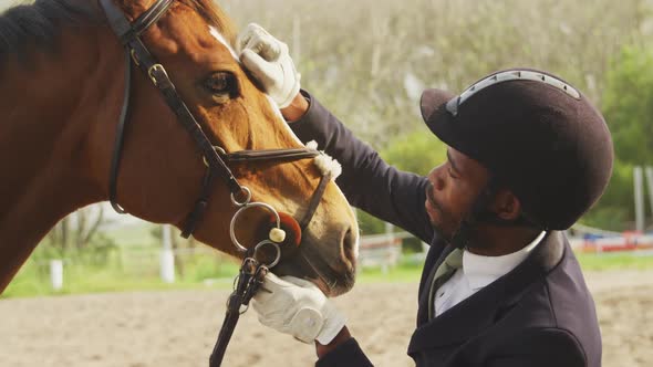 African American man caressing his Dressage horse