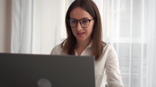 Young Business Woman Talks To Web Camera Making Distance Online Video Conference Call