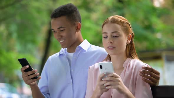 Offended Girl Dislike Afro-American Boyfriend Chatting Smartphone, Jealousy