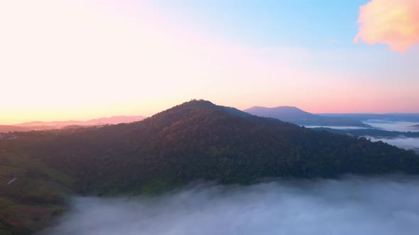 Flying over the clouds during morning sunrise