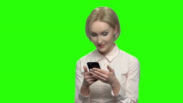 Elegant Businesswoman Texting on a Mobile Phone