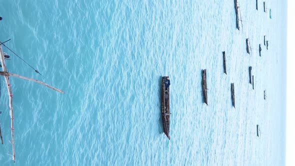 Vertical Video Boats in the Ocean Near the Coast of Zanzibar Tanzania Aerial View