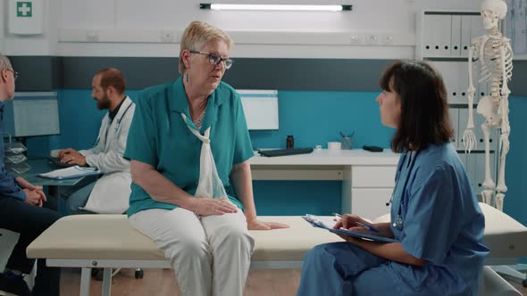 Senior Woman Having Conversation with Medical Assistant