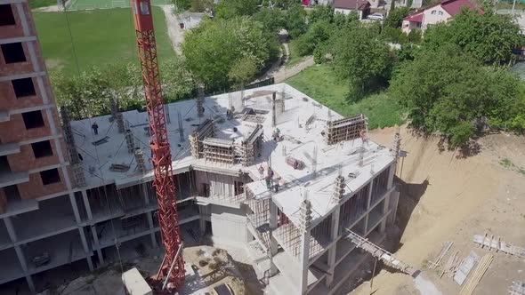 Topdown Aerial View on the Roof of an Office Skyscraper in a Multiworker Building and a Tower Crane