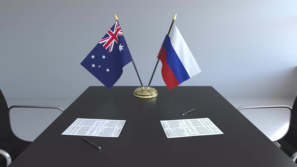 Flags of Australia and Russia and Papers on the Table