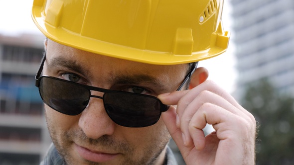 Young Handsome Engineer Man Wearing Safety Helmet in Sunglasses