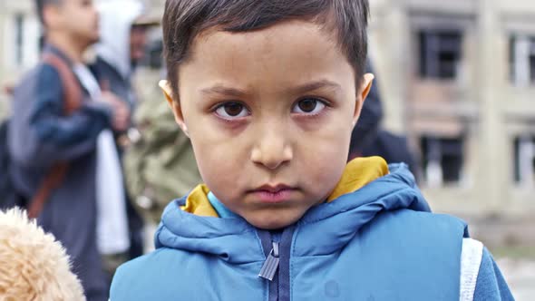 Sad Little Refugee Boy with Plush Toy