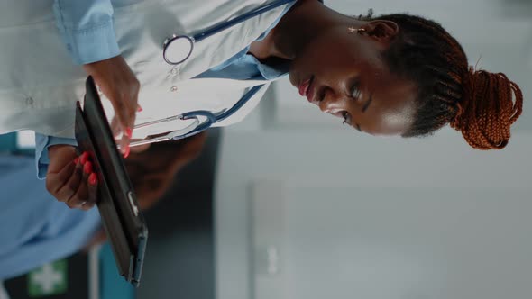 Vertical Video Medic Looking at Tablet Screen for Healthcare System