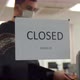 A Man in the Office Changes the Sign 'Closed' to 'We are Open' - VideoHive Item for Sale