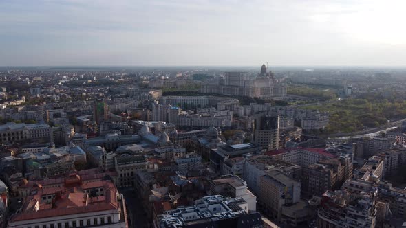 Aerial View Of Bucharest City Center Skyline Buildings In Romania On A Sunny Day. drone pullback