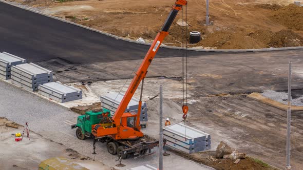 Installing Concrete Plates By Crane at Road Construction Site Timelapse.