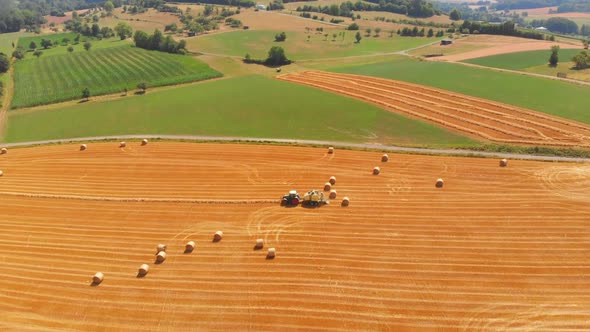 tractor harvesting golden ripe barley fields.