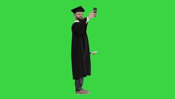 Excited Graduate Student Taking a Selfie on a Green Screen, Chroma Key.