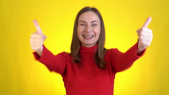 Handsome Smiling Woman Isolated on Yellow Background in Studio