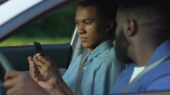 Anxious Black Dad Grabbing Son Smartphone Trying to Control Teenager Conflict