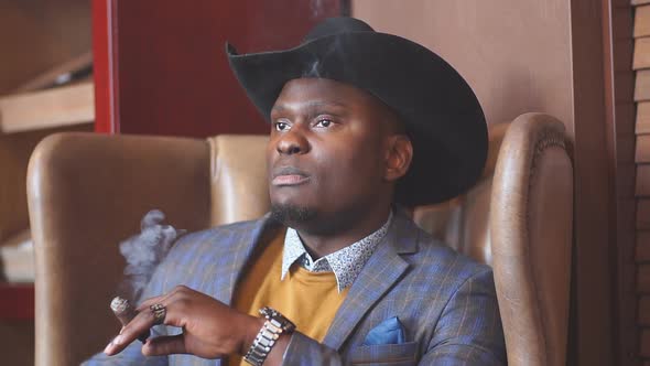 Black Man Smoking Cigar Portrait with Hat