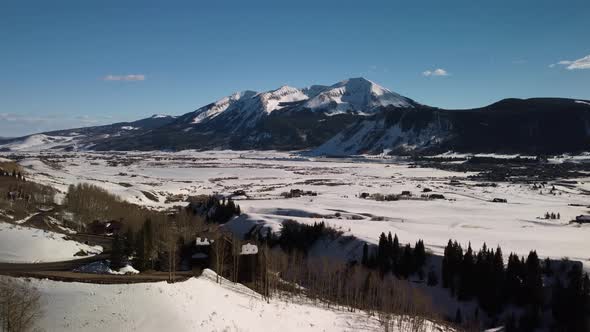 Flying towards Snowcapped Colorado Rocky Mountains during the winter, Aerial