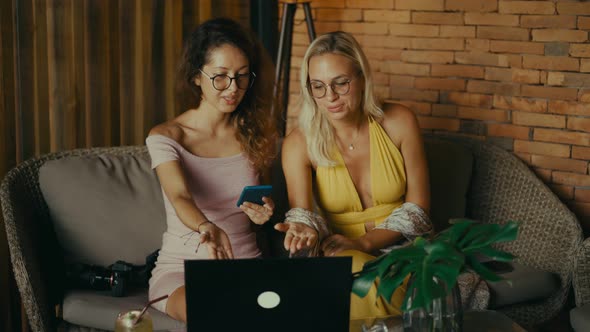 Two Cheerful Women with Laptop