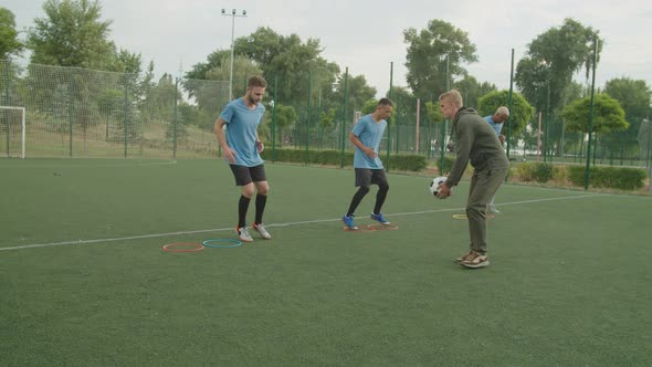 Soccer Players Performing Exercise with Agility Speed Circles Outdoors