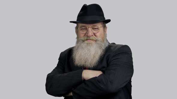 Portrait of and Old Business Man in Suit with His Arms Crossed