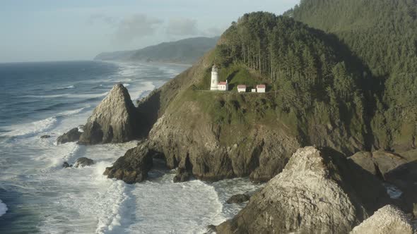 Fast tracking aerial of Haceta Head lighthouse in Oregon