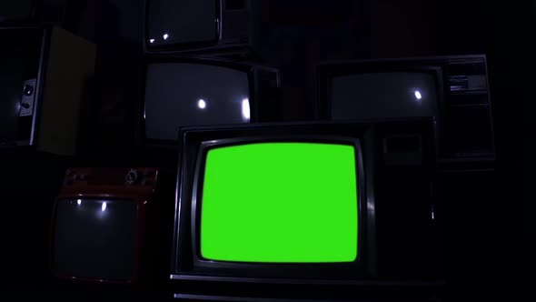 Old TV Set Turning On Green Screen. Night Time. Zoom In.